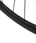 Close-up of matte black rim detailing on Carbon Disc Wheelset 50C-25 Clincher Road Wheels UD Matte Finish Six Bolt 12x100 Front And 135QR Rear Lightweight And Stiff For Fast Rolling Aerodynamic Performance And Fatigue Reduction On Long Rides.