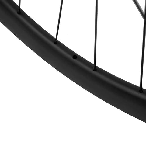 Close-up of matte black rim detailing on Carbon Disc Wheelset 50C-25 Clincher Road Wheels UD Matte Finish Six Bolt 12x100 Front And 135QR Rear Lightweight And Stiff For Fast Rolling Aerodynamic Performance And Fatigue Reduction On Long Rides.