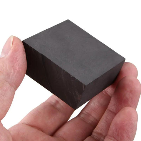 Hand holding Graphite Sheet Plate Block And Strip For Scientific Research And University Teaching Labs Pro Grade High Purity Graphite