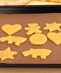 Cookie dough shapes on PTFE Teflon sheet for heat press 16x24 inches, non-stick ultra high-temp, heat resistant for DIY projects and baking.