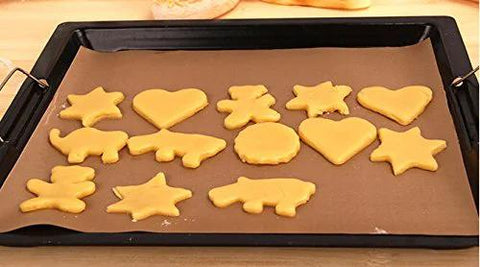 Cookie dough shapes on PTFE Teflon sheet for heat press 16x24 inches, non-stick ultra high-temp, heat resistant for DIY projects and baking.