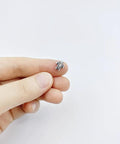 Hand holding a tiny antique silver turtle bead 0.9x0.7cm for crafts from 100 Pcs Dope Tiny Turtle Beads Antique Silver 0.9x0.7cm set