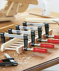Heavy Duty General Purpose Clamp With Zinc Die Cast Jaws Delivers Up To 330 Pounds Of Clamping Power, shown securing wood pieces