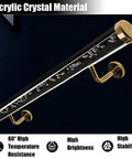 Slick Clear Acrylic Stair Railing Featuring Brushed Gold Brackets close-up of polished steel and acrylic material, showcasing high brightness and stability.