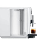Straight Up Game Changer Automatic Espresso Coffee Maker With Easy Cappuccino Function And Premium Aroma Grinder In Sleek Piano White Finish, side view showing glass with espresso.