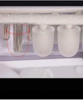 Inside view of Portable Countertop Ice Maker Machine, showing ice cube mold and ice production area for quick freeze.