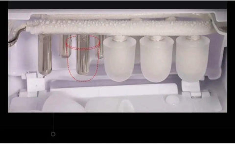 Inside view of Portable Countertop Ice Maker Machine, showing ice cube mold and ice production area for quick freeze.