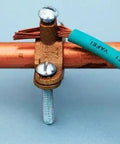 Heavy Duty Bronze Water Pipe Ground Clamp Fits One Quarter To Two Inches mounted on copper tubing with wire connection.