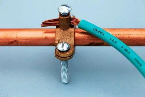 Heavy Duty Bronze Water Pipe Ground Clamp Fits One Quarter To Two Inches mounted on copper tubing with wire connection.