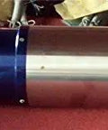 Kickass 24000 RPM 1.5KW Water Cooled CNC Spindle Motor Featuring ISO20 80mm Taper And 400Hz Lightning Fast Automatic Tool Exchange side view on red surface.