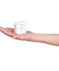 Hand holding a white Indoor Smart Motion Sensor 2 Pack With Daylight Sensing Auto On When You Roll In And Auto Off When You Roll Out