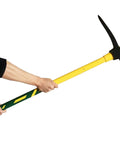 Person holding Beast Mode Heavy Duty Forged Mattock With Adze and ergonomic non slip handle, 36 inch, for outdoor digging and cultivating.