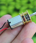 Hand holding Three Mini Micro N20 Gear Motors DC 3V To 6V with full metal gearbox, slow speed, high torque 3mm D type shaft.