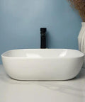 USZWBY Vessel Sinks Square Rounded Corner Simple Sink Ceramic Above Counter Wash Basin in a modern bathroom setting.