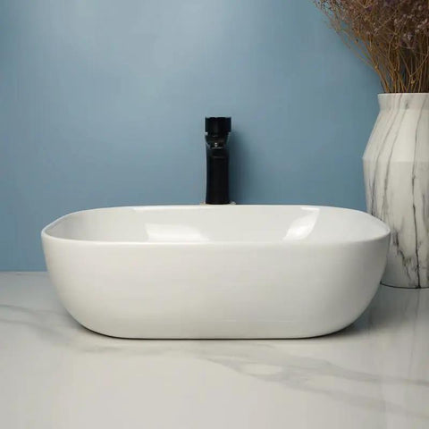 USZWBY Vessel Sinks Square Rounded Corner Simple Sink Ceramic Above Counter Wash Basin in a modern bathroom setting.