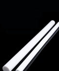 White PTFE Rod Bearing For Precision Machinery 4-200mm Diameter 190mm Length Low Friction Teflon Rod shown with two rods on black background