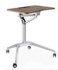 Game Changer Height Adjustable Standing Desk With Silky Gas Lift And Ultra Quiet Lockable Rubber Wheels mobile desk with a wood top and aluminum base.