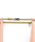 Hands holding a khaki strap from 4 Pack Luggage Binding Straps Cinch Ratchet Belts For Travel Bags Golf Cart Bags Backpacks And Camping Gear