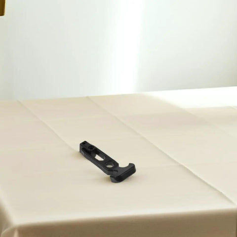 Close-up of a black rubber latch from Rubber Engine Hood Latches 4 Pack for Trucks and Cargo Trailers on a white surface.