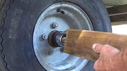 Installing Trailer Hub Cap Protector In Stainless Steel Bearing Buddies, 1.98 Inch Diameter, keeps water and dirt out of trailer hubs.
