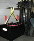 Industrial forklift battery lifting sling, front view, yellow straps lifting a large black battery beside a forklift.