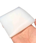 Person holding a white High Temperature Resistant Silicone Sheet For Damping And Insulation, 100x100mm, 1mm thick
