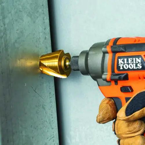 Heavy Duty Step Drill Bit Set For DIY With Spiral Double Fluted Titanium Nitride Coated Bits in use with a drill on metal surface