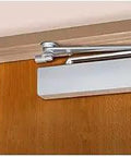 Grade 1 Surface Door Closer With Spring Stop Arm, Push Side Mount, Size 1-6, Non-Handed, Sprayed Aluminum Finish on wooden door
