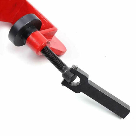 Close-up of a Bead Roller Machine with 7 Inch Throat and Six Die Sets, showing red handle and metal bender for auto industry use.