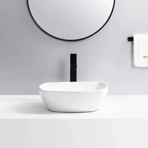 Bathroom Sink Bathroom Vessel Sink Household Ceramic Wash Basin Hotel Countertop Basin Ceramic Vessel Sink Square Art Basin Bathroom Sink Vessel installed on white countertop with round mirror.