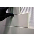 Installing tiles on a wall using One Gallon White Pre Mixed Tile And Stone Thin Set Mortar For DIY Friendly Tile Installations.