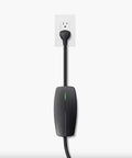 Tesla Mobile Connector Portable EV Charger Level 2 Up To 32 Amps With 20 Ft Cable plugged into a standard outlet.