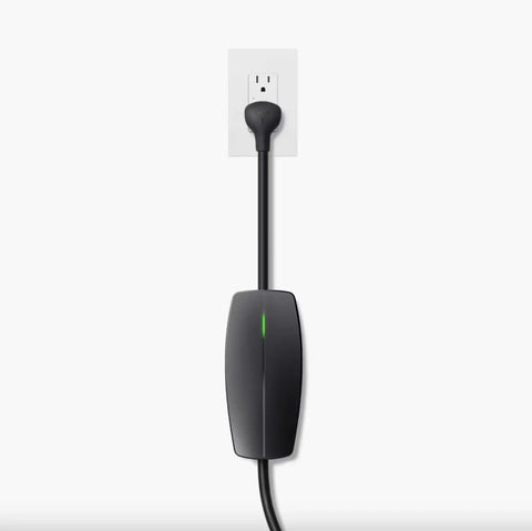 Tesla Mobile Connector Portable EV Charger Level 2 Up To 32 Amps With 20 Ft Cable plugged into a standard outlet.