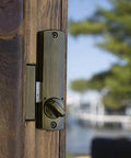 C150AB surface-mount hook bolt latch on wooden post, bronze finish