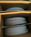 Insulated copper coil line, 1/4-in tube with white 1/2-in insulation, coiled in cardboard boxes