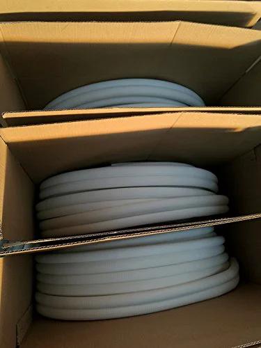 Insulated copper coil line, 1/4-in tube with white 1/2-in insulation, coiled in cardboard boxes