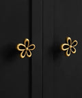 Bougie Antique Brass Flower Cabinet Knobs Vintage Aesthetic Boho Decor Hardware Set of 4 on black cabinet doors.
