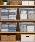 Heavy Duty 105 Quart Storage Bin With Secure Snap Latches And Clear Base Keeps Bedding And Sports Gear Safely Stacked Away In A Fly Blue Container That Makes Home Organization A Real Game Changer, filled with neatly stacked linens.