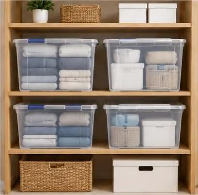 Heavy Duty 105 Quart Storage Bin With Secure Snap Latches And Clear Base Keeps Bedding And Sports Gear Safely Stacked Away In A Fly Blue Container That Makes Home Organization A Real Game Changer, filled with neatly stacked linens.