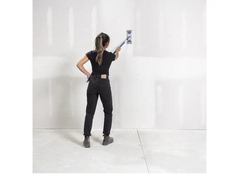 Person applying 18Lb EZ Sand 45 Joint Compound for drywall and painting projects, sandable natural gypsum formula pro grade