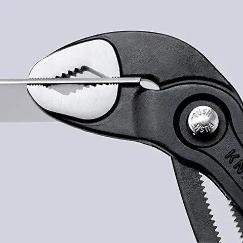 Close-up of Cobra Water Pump Pliers 7 And A Quarter Inch Beefy Self Locking Pliers With Teeth Grip on metal object