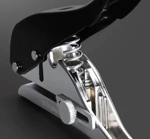 Close-up of Beast Of A Heavy Duty Single Hole Punch Handheld Paper Punch for crafts showing ergonomic handle and built-in spring