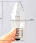 Warm White Incandescent Torpedo Tip Chandelier Bulbs With Frosted Clear Glass For E26 E27 Medium Bases held in hand showing size