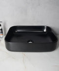 USZWBY Vessel Sinks Modern Simple Household Black Wash Basin Ceramic Above Counter Hotel Bathroom Countertop Bathroom Bowl Sink on marble surface.