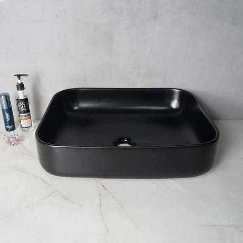 USZWBY Vessel Sinks Modern Simple Household Black Wash Basin Ceramic Above Counter Hotel Bathroom Countertop Bathroom Bowl Sink on marble surface.
