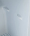 Interior view of Hella Cool 1.1 Cubic Foot Compact Upright Freezer With Slick Removable Baskets Reversible Door, showing white walls.