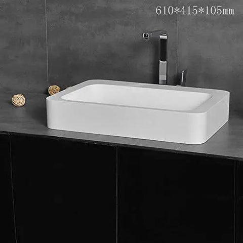 Slick Rectangular Bathroom Vessel Sink Crafted From Heavy Duty Artificial Stone Table Top Basins Featuring Thick Edges That Hold Up Over Years Durable White Countertop Washbasin on modern vanity.
