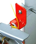 Detail of a red and silver Fifty Pack Hella Tough I Beam Clamp for securing fire extinguishers, showing secure mounting and setup.