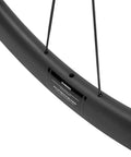 Close-up of Tubeless 45mm Carbon Road Wheelset, showing 700c rims, 25mm wide, disc brake compatible, carbon fiber Toray T700 spokes.