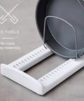 StoreMore Adjustable Bakeware Rack With Steel Wires Seven Adjustable Dividers organizing a round pan on a countertop